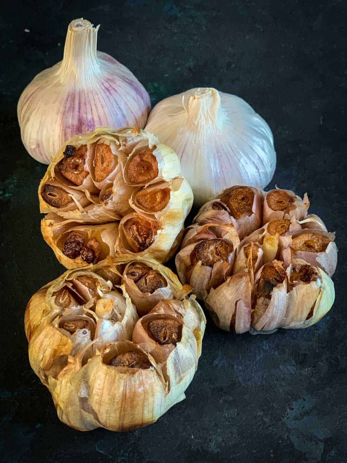 Whole raw and roasted garlic bulbs