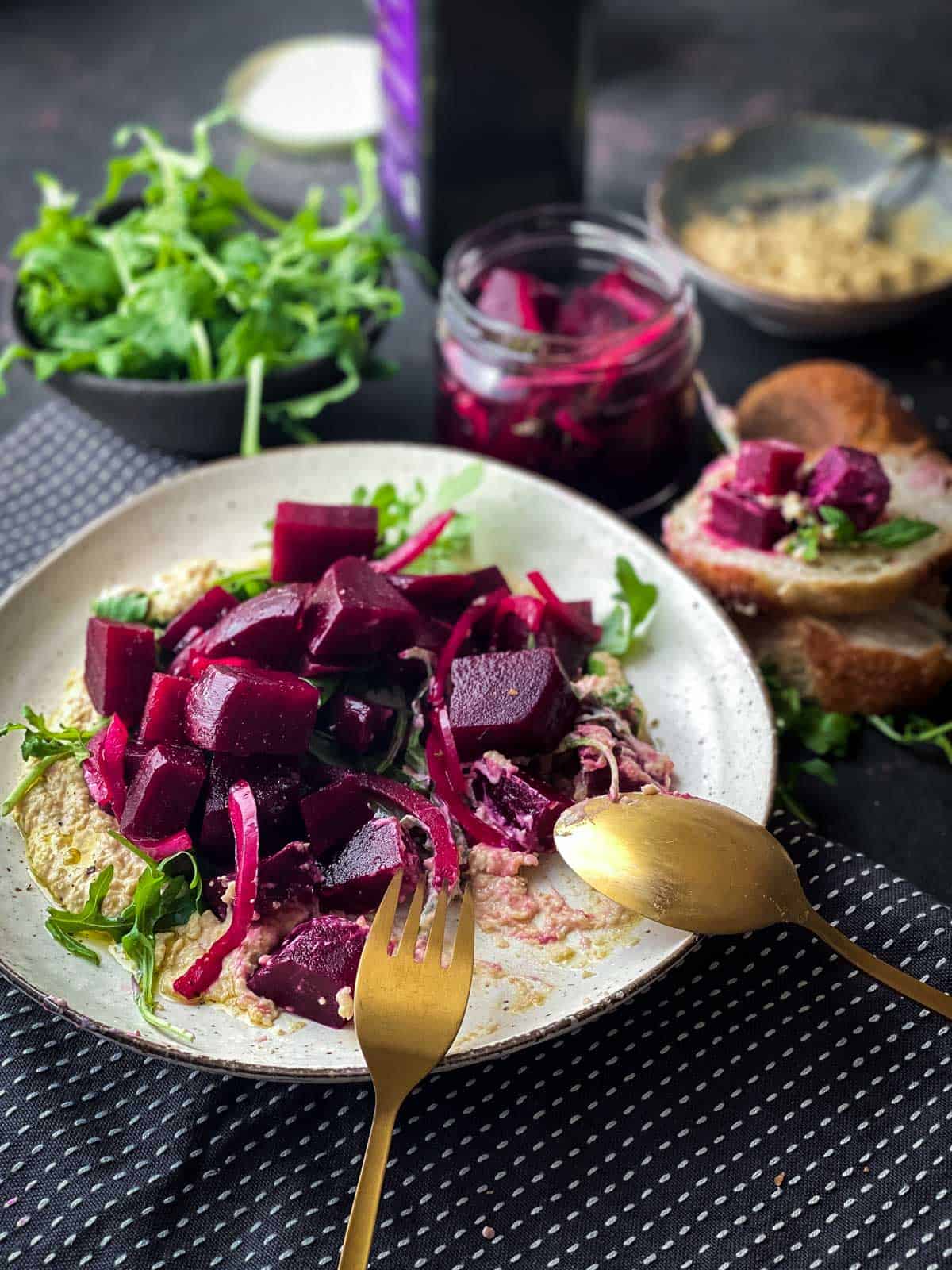 Pickled Beet Salad with Chickpea Mash served on fresh bread with arugula