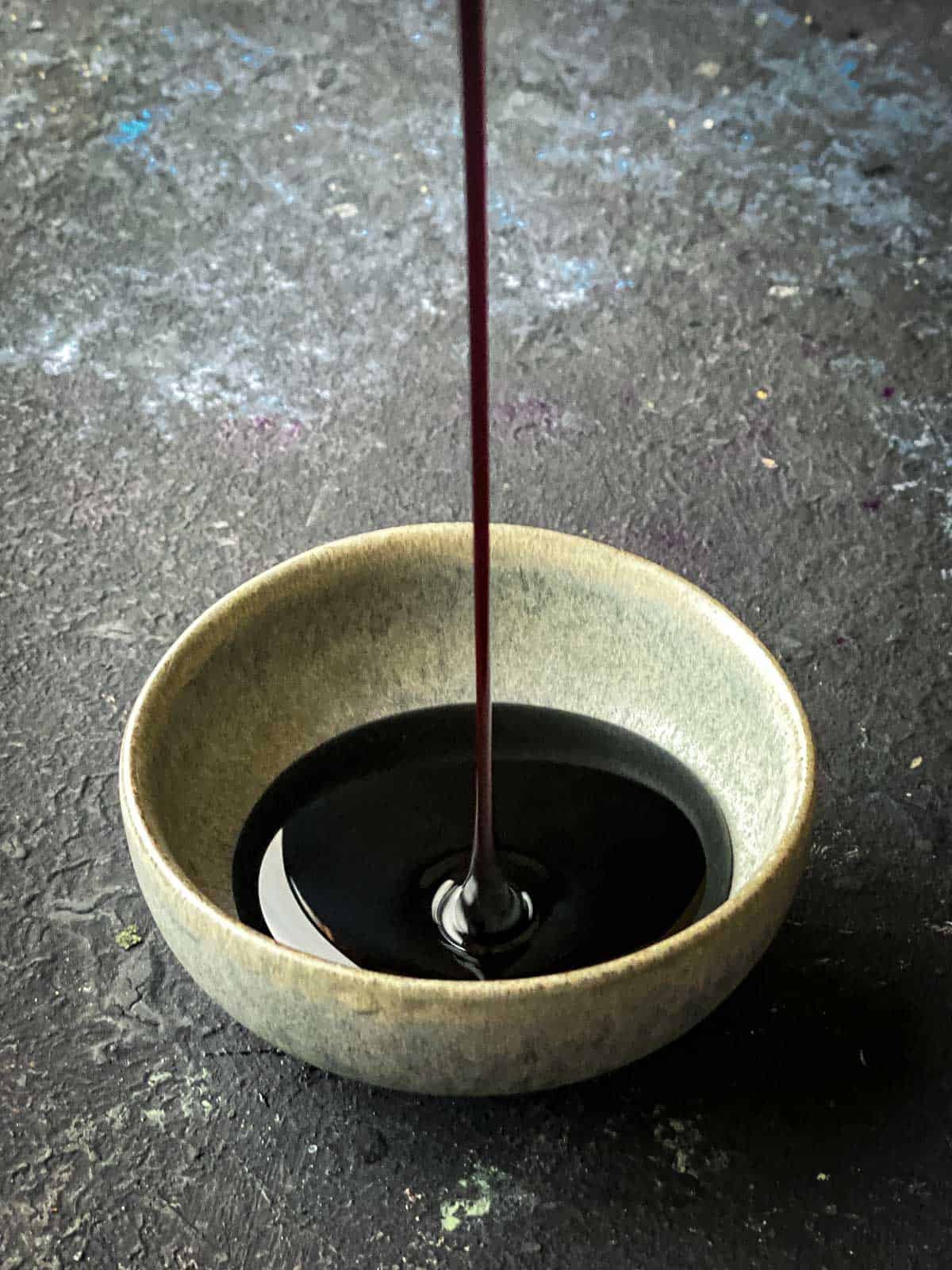 Pouring kecap manis into a bowl