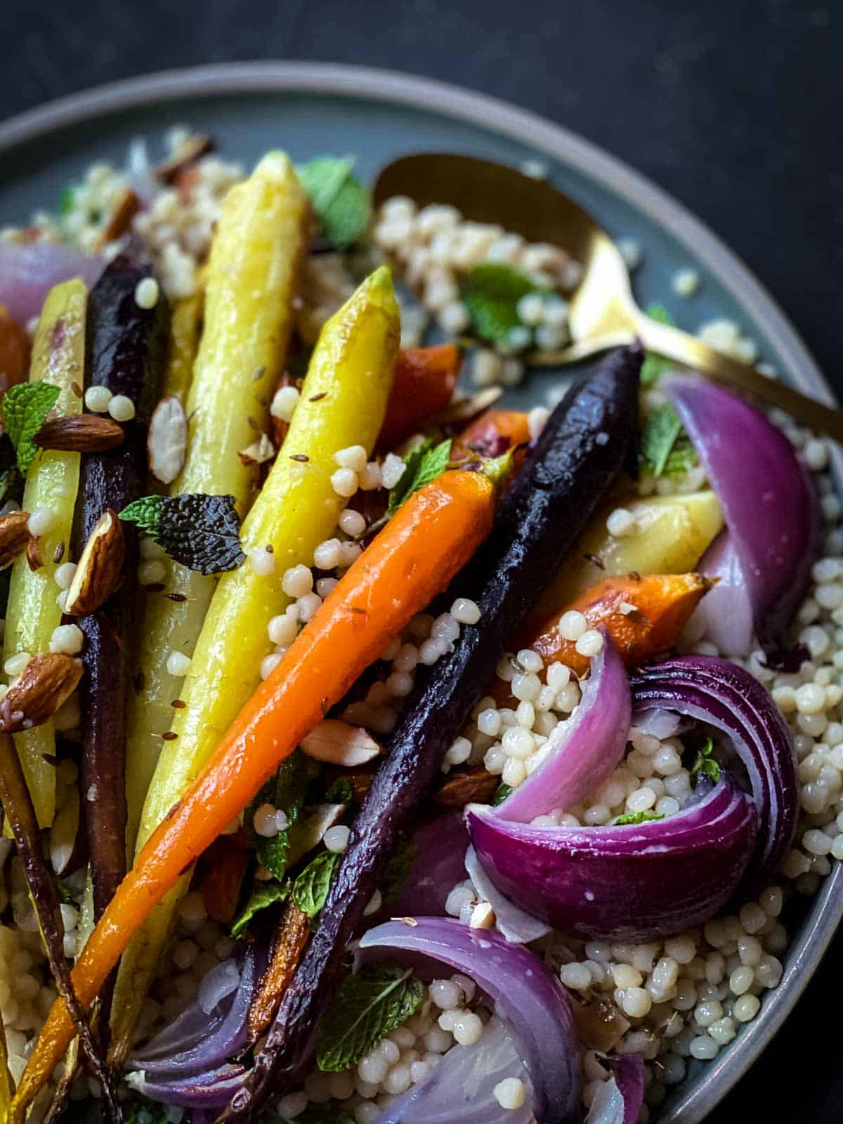 Roasted Rainbow Carrots with Pearl Couscous on a green plate