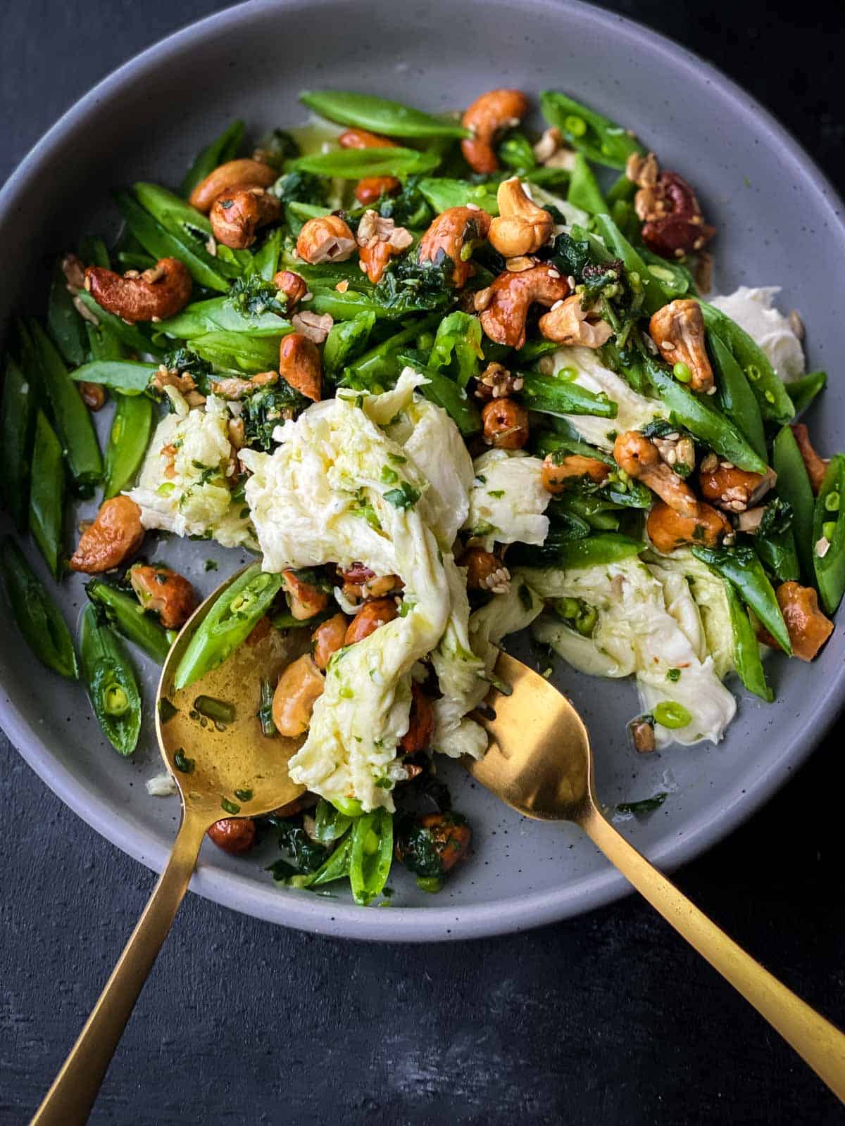Sugar Snap Pea Salad with Fior di Latte in a grey bowl with gold spoon and fork