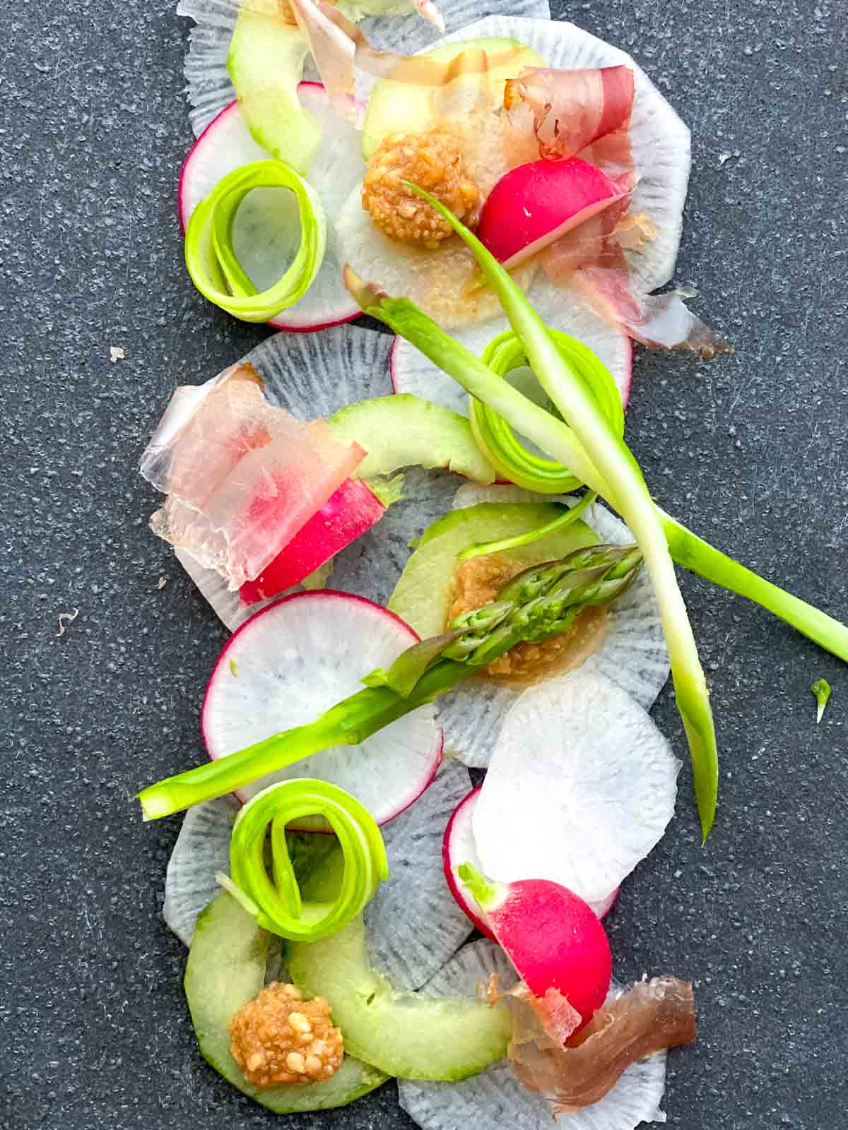 Shaved Asparagus and Daikon Salad on a stone platter