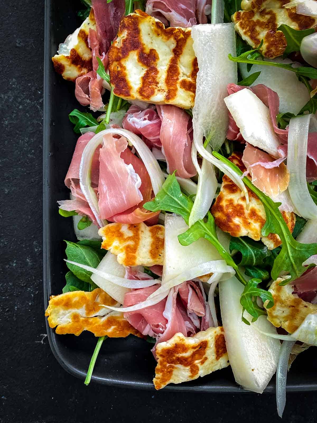 Canary Melon Salad with Halloumi in an oblong platter