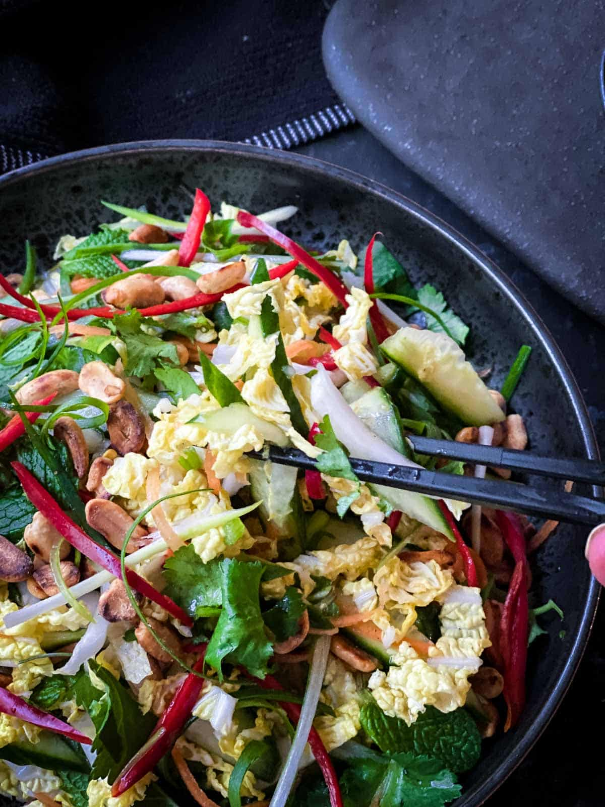 Chopsticks lifting a serve of Chinese Cabbage Salad