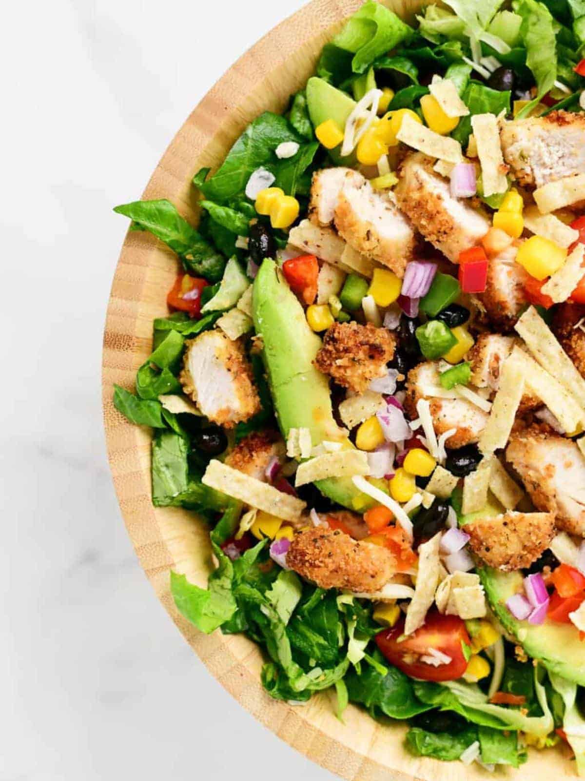 Chipotle chicken salad in a wooden bowl