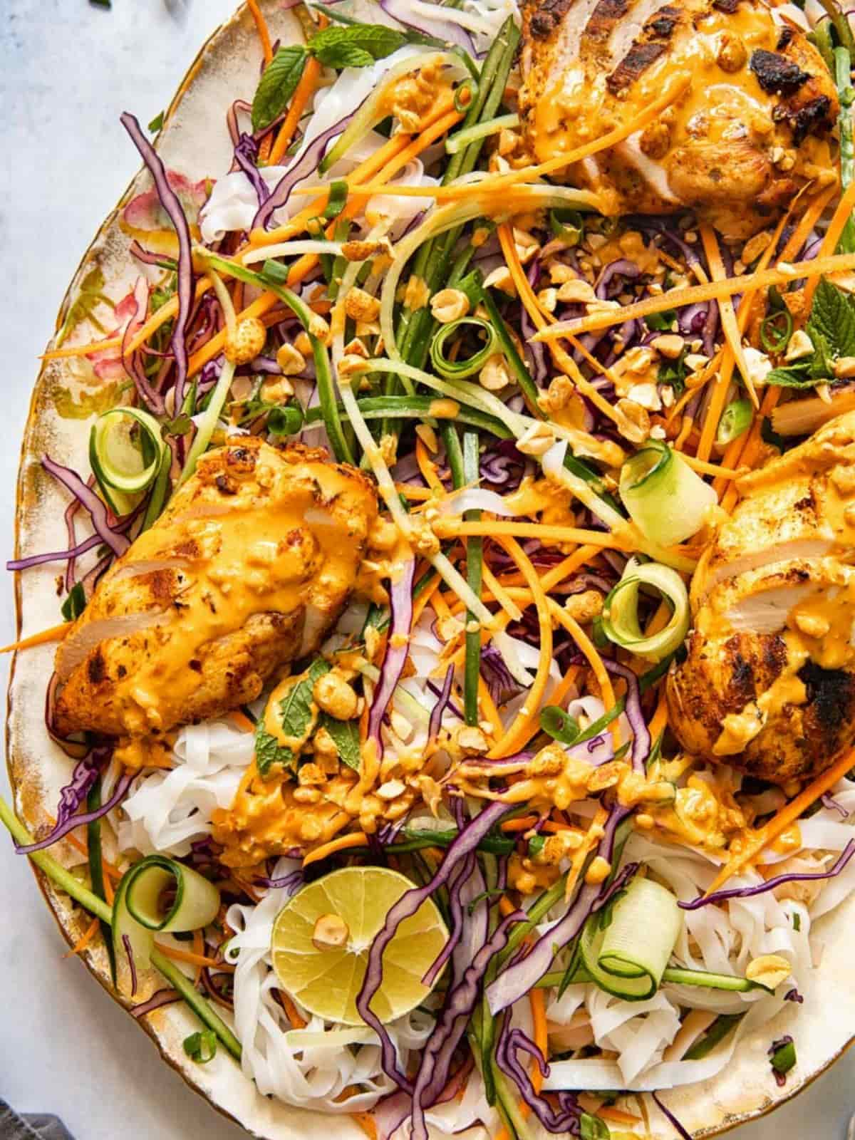 Thai grilled chicken salad on a vintage white platter