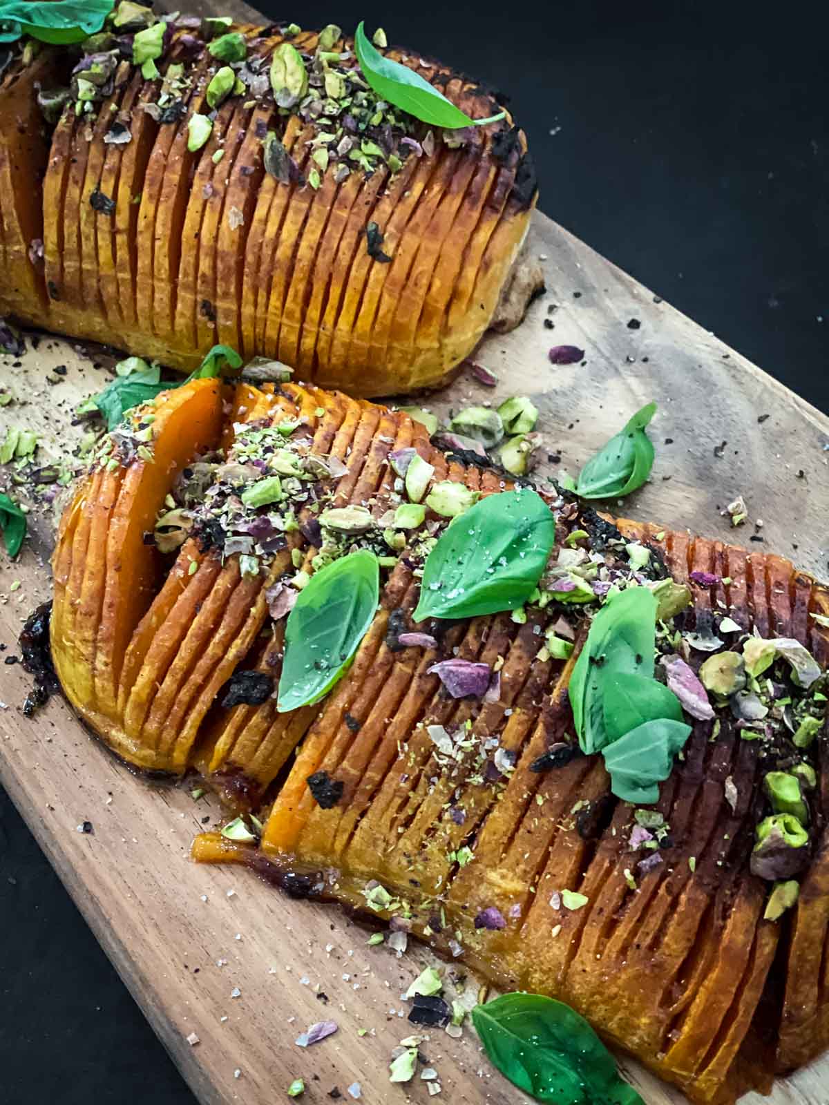 Hasselback Butternut Squash in Garlic Butter on a wooden board