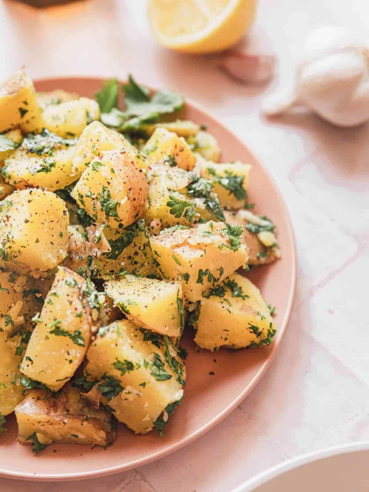 Lebanese potato salad on a pink plate