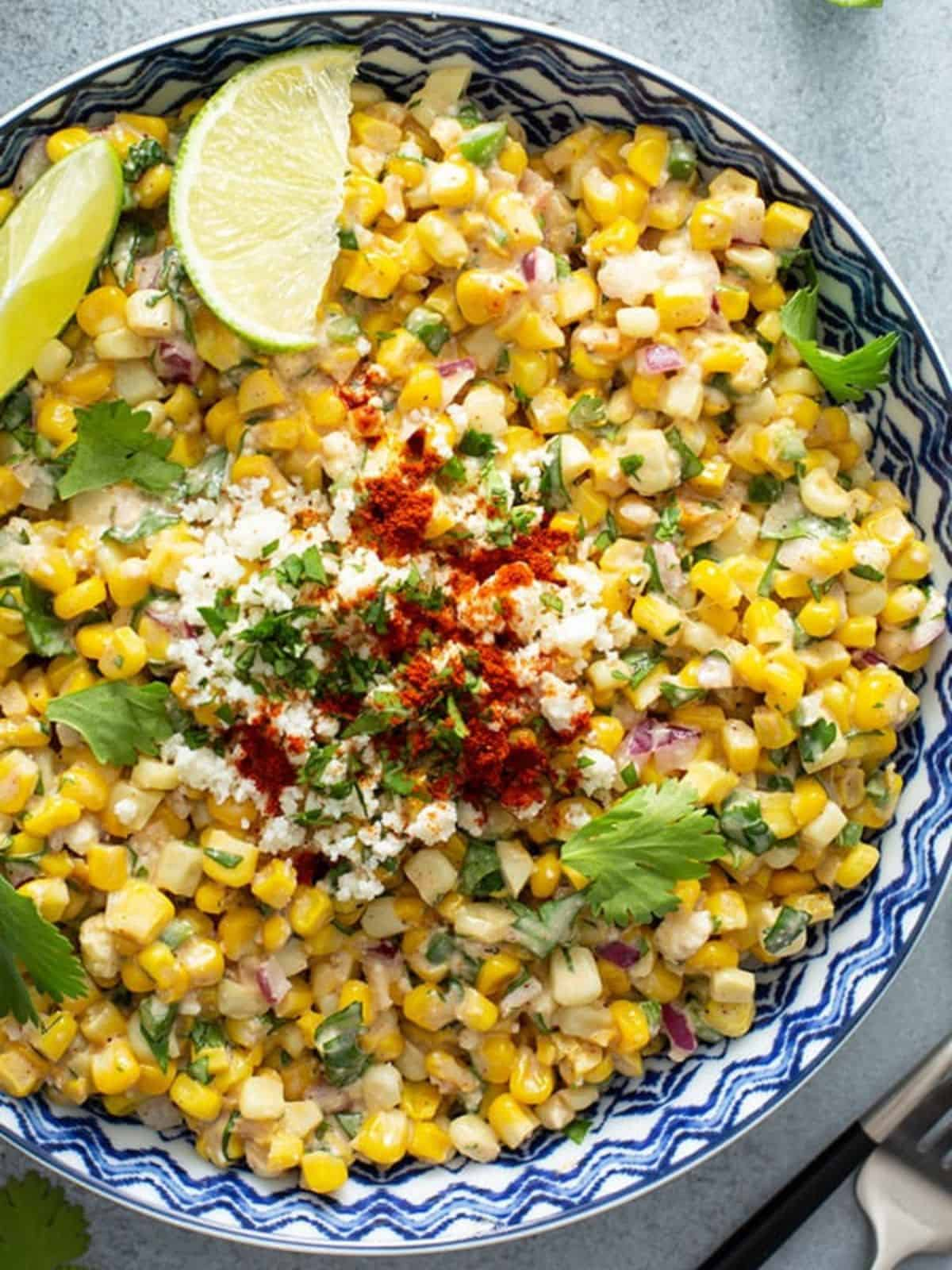 Mexican street corn salad in a blue and white pattern bowl