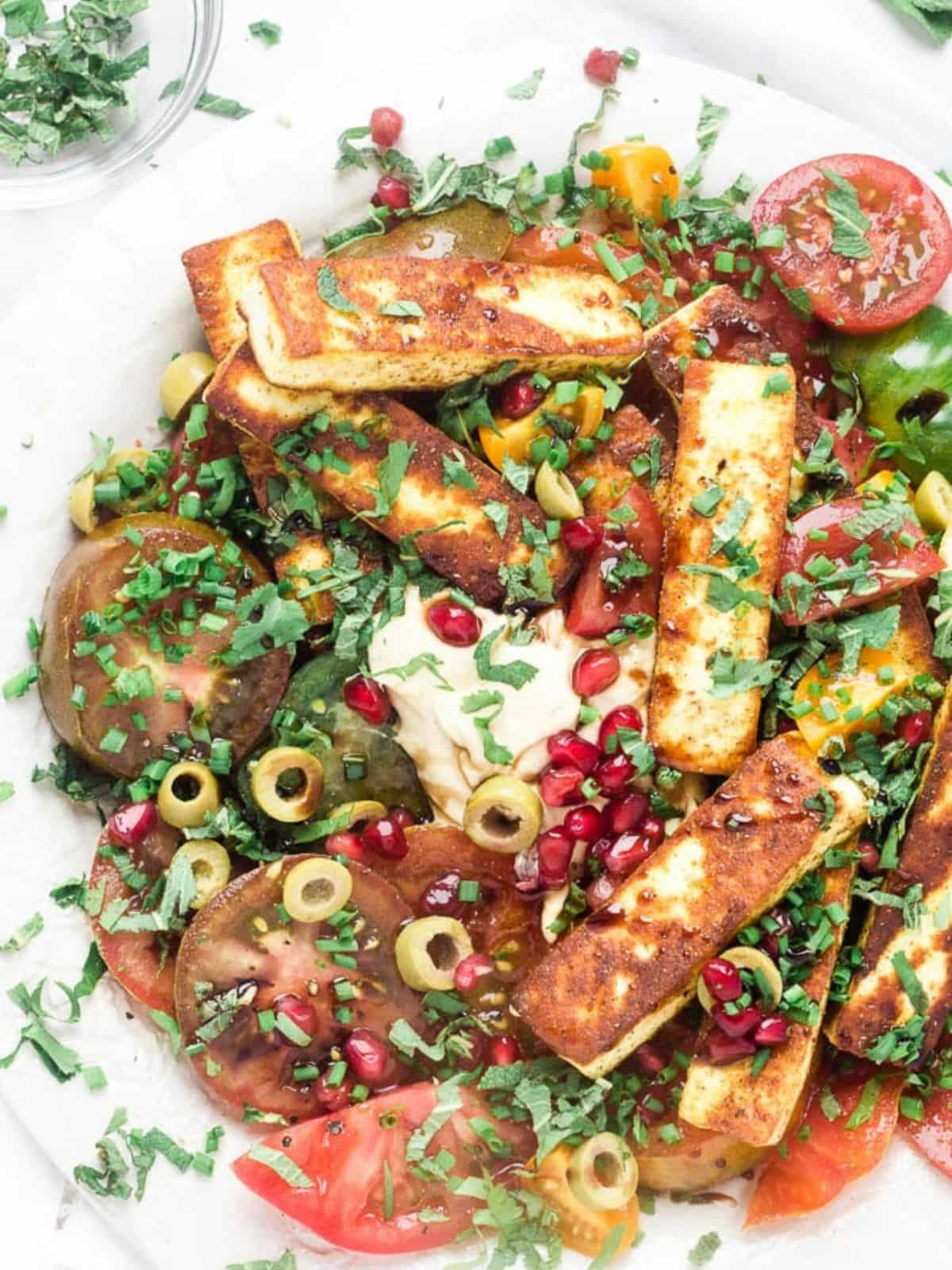 Paneer tomato salad on a white plate