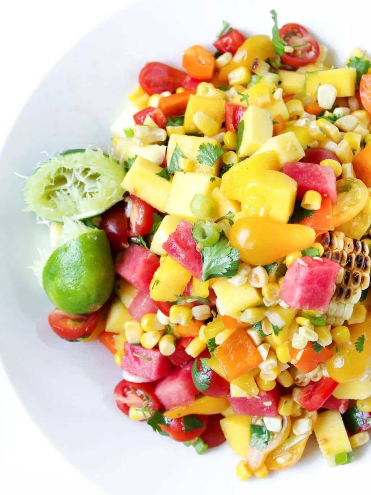 Watermelon salad with corn on a white plate