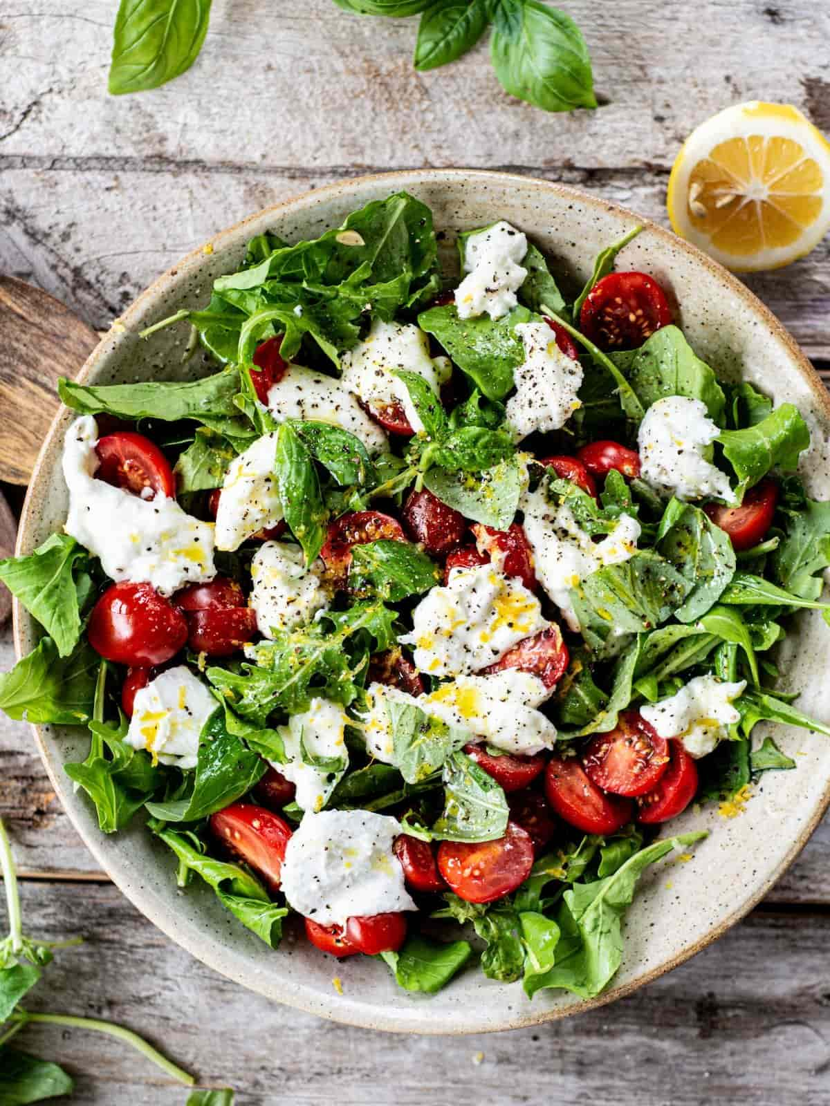 Arugula caprese salad on a white bowl