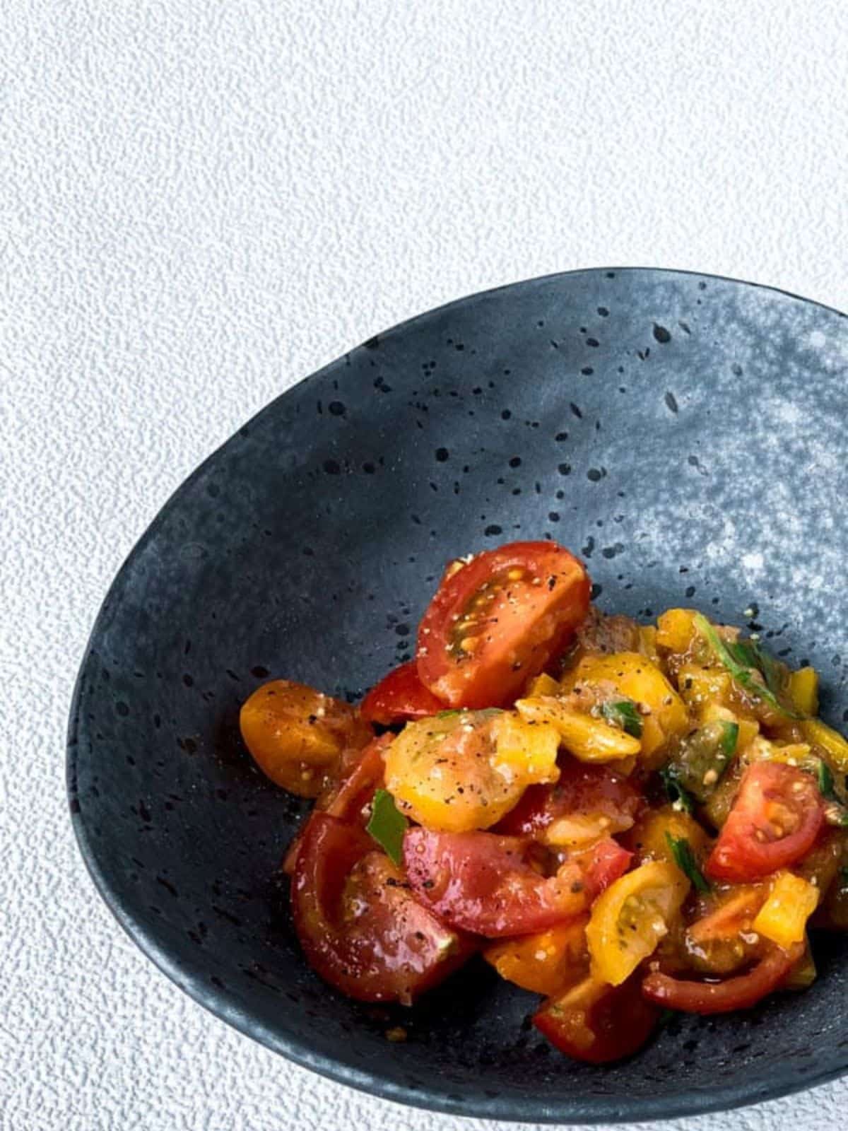 Cherry tomato salad in a grey plate