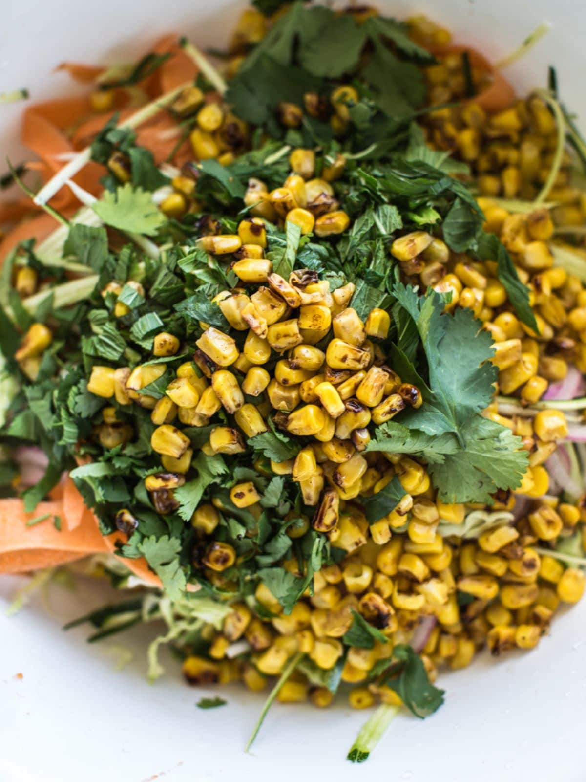 Roasted corn and zucchini salad in a bowl