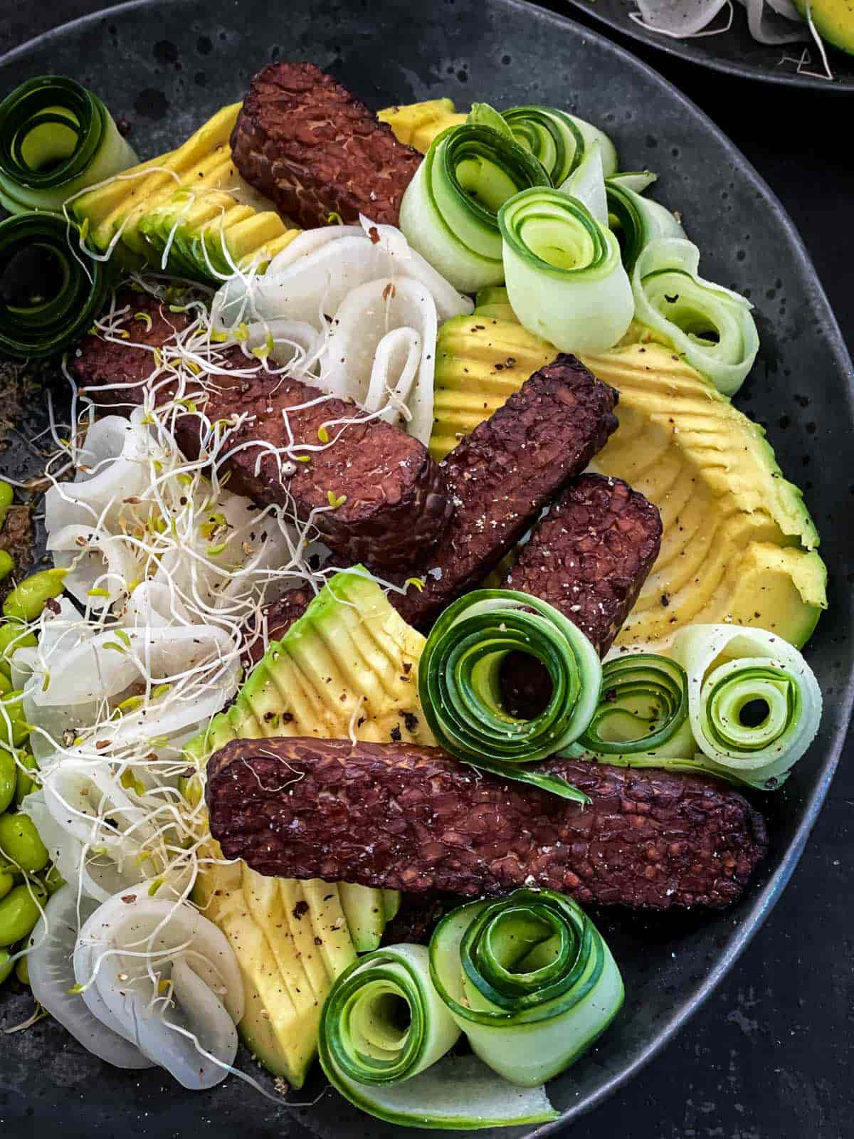 Close up of Baked Tempeh Salad on a grey plate