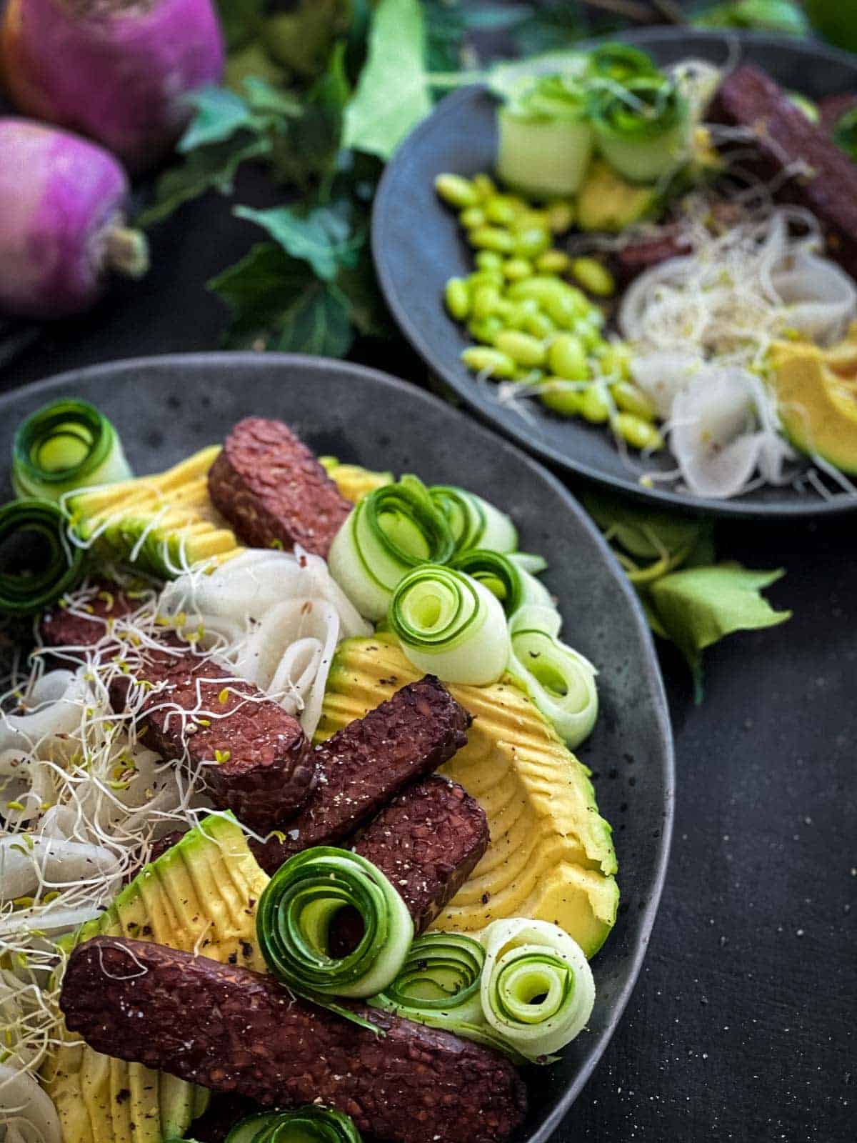 2 serves of Baked Tempeh Salad on a grey plates