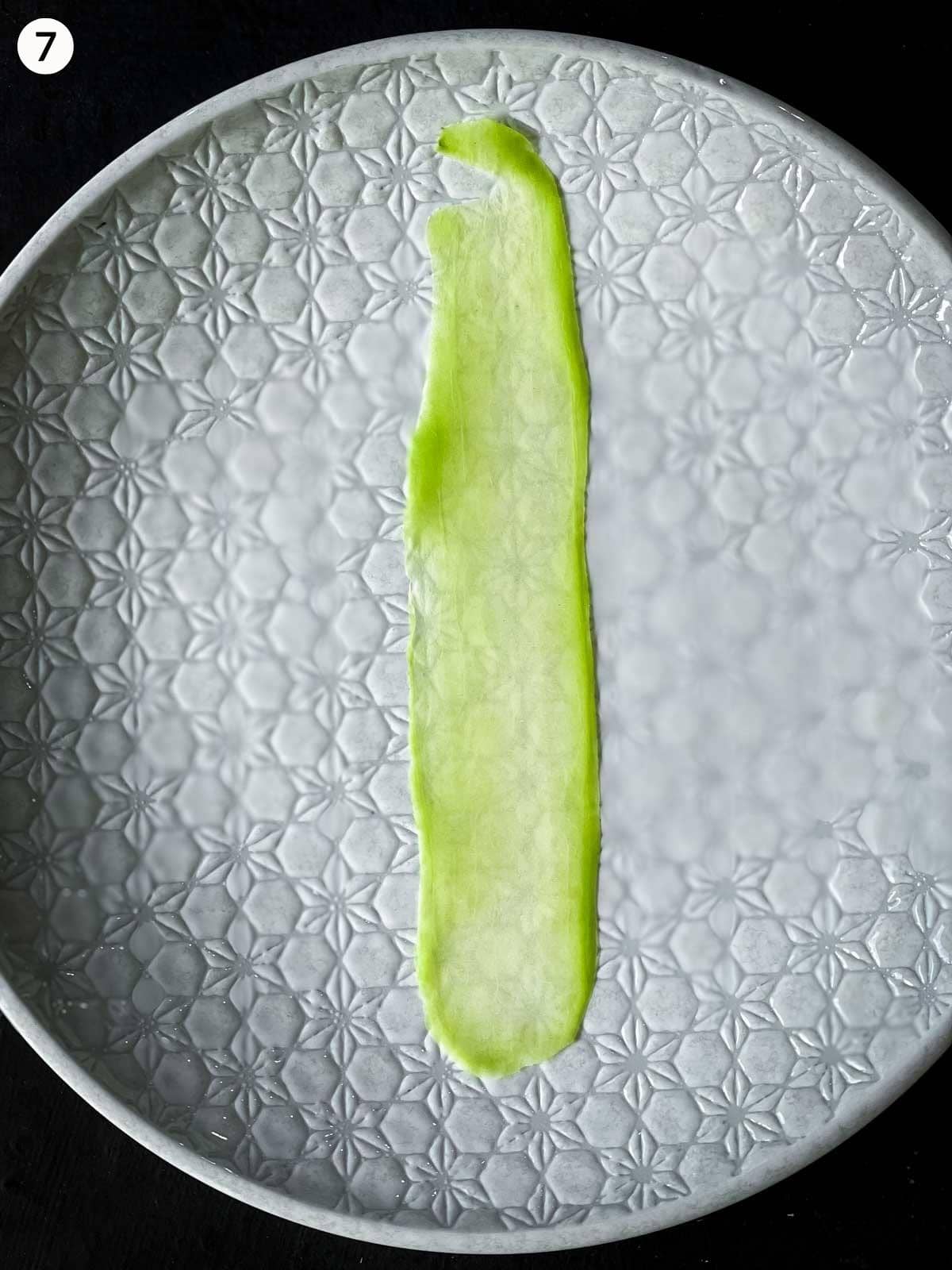 a strip of shave Chinese squash on a white plate