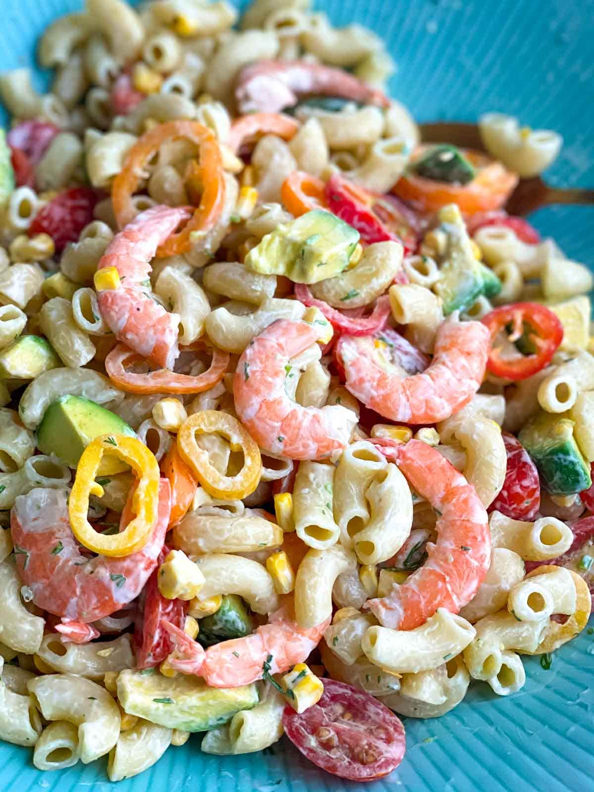 close up of blue bowl with shrimp macaroni salad