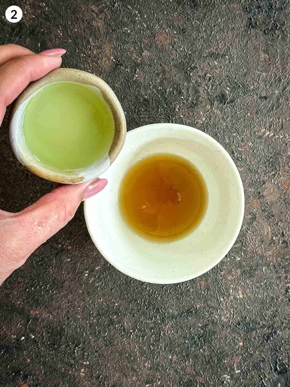 Adding lime juice into a bowl with fish sauce