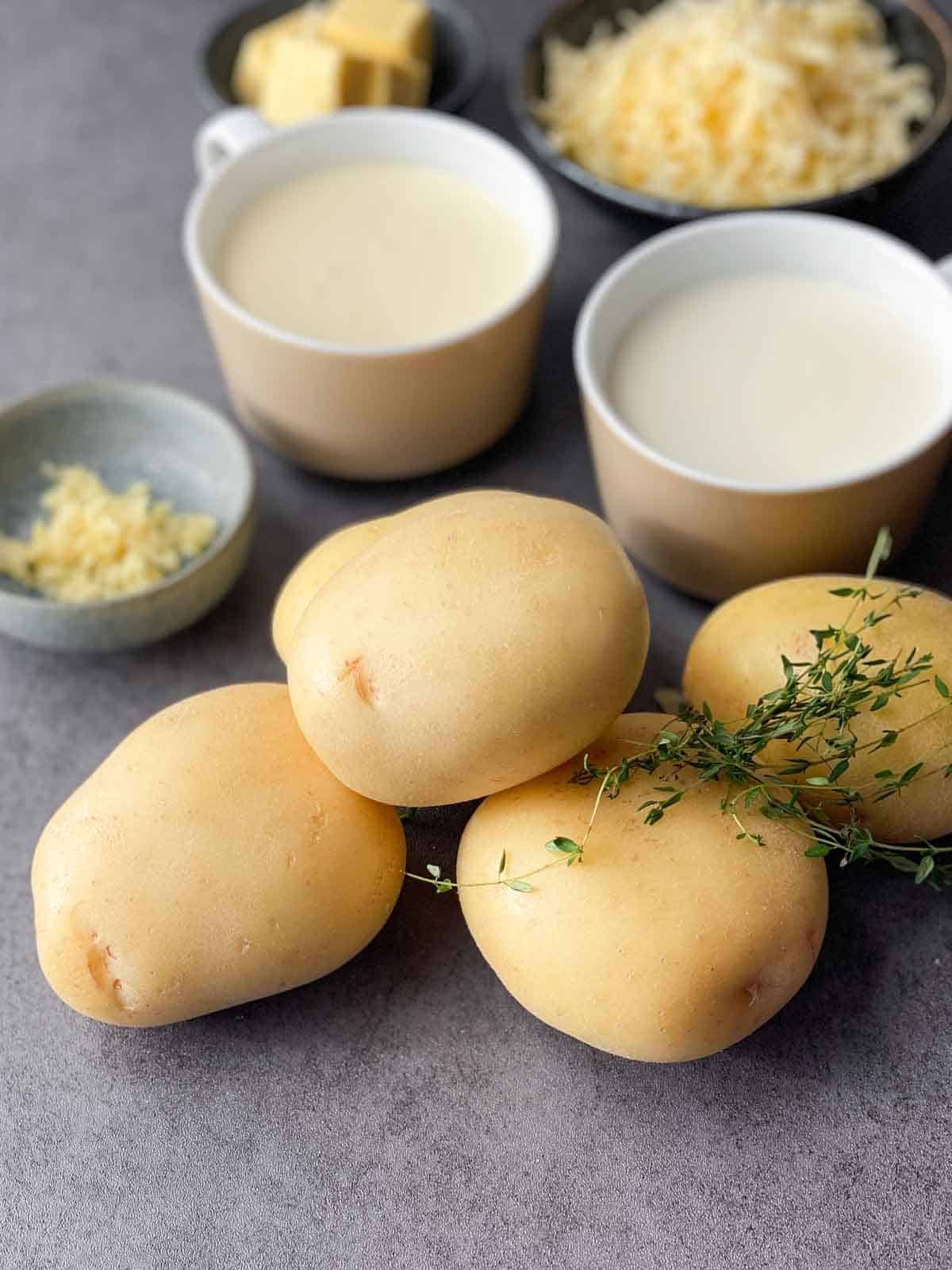 4 whole potatoes with fresh thyme, garlic, cream and grated cheese on the side