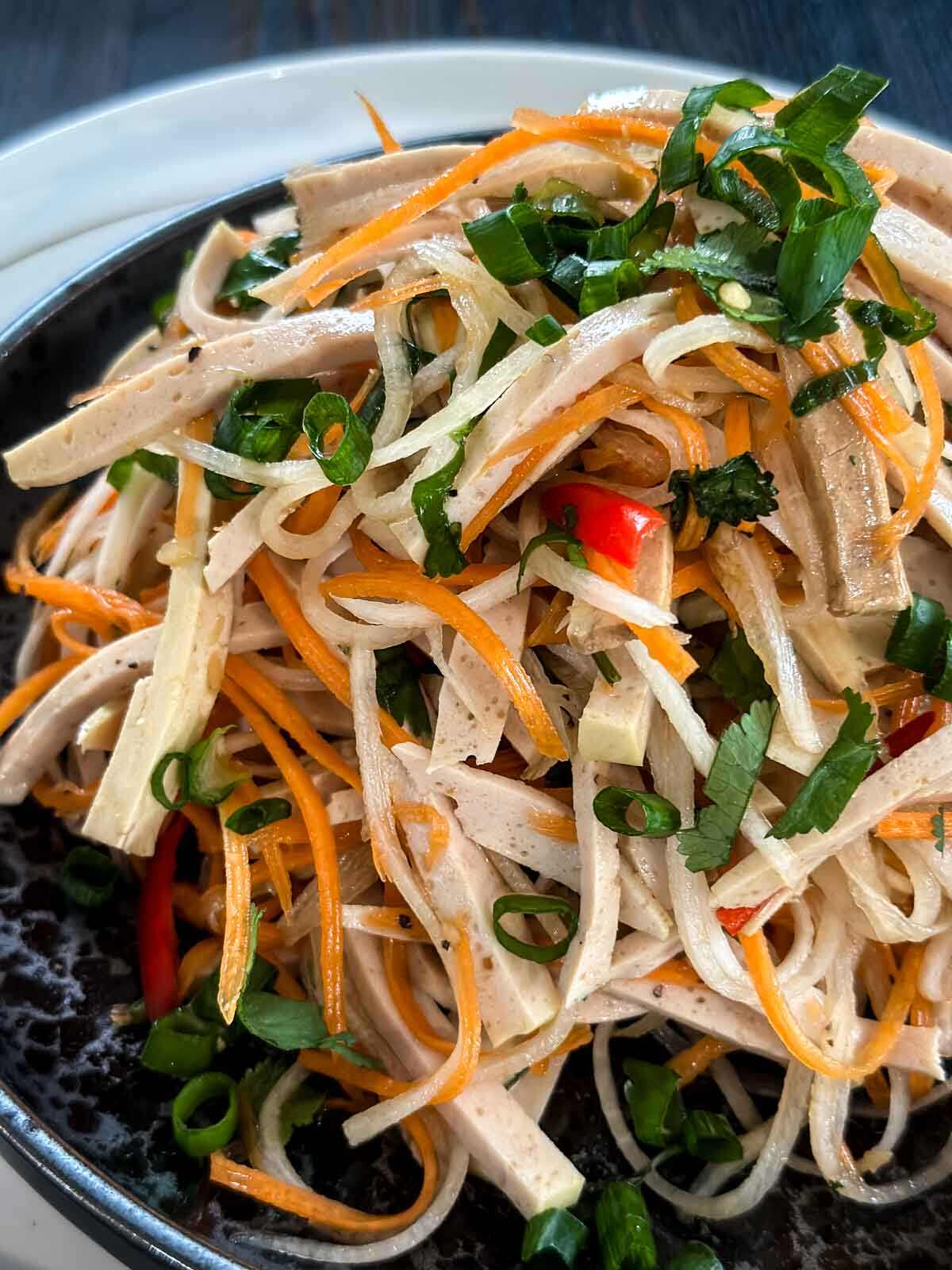 Close up of Vietnamese Ham Salad in a black plate