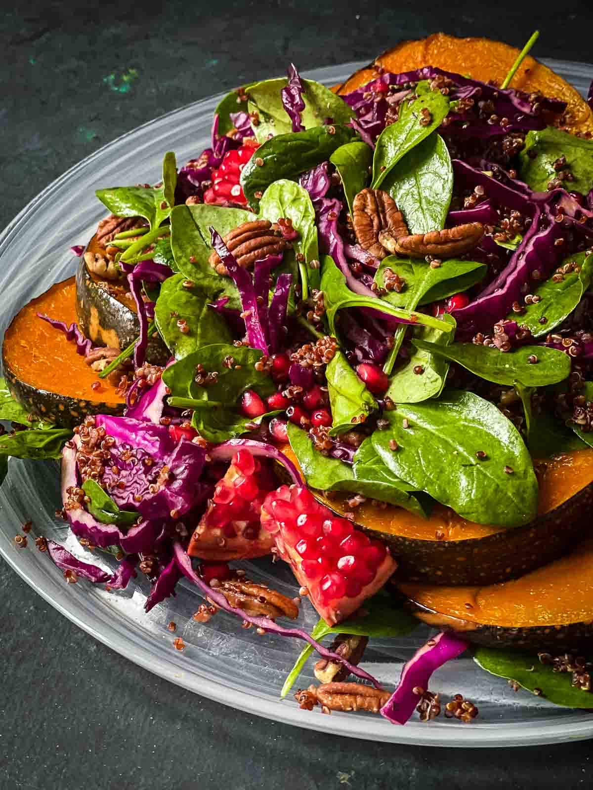 Quinoa Pumpkin Salad served on a white platter against a dark background