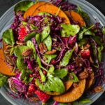 Quinoa Pumpkin Salad served on a white platter against a dark background