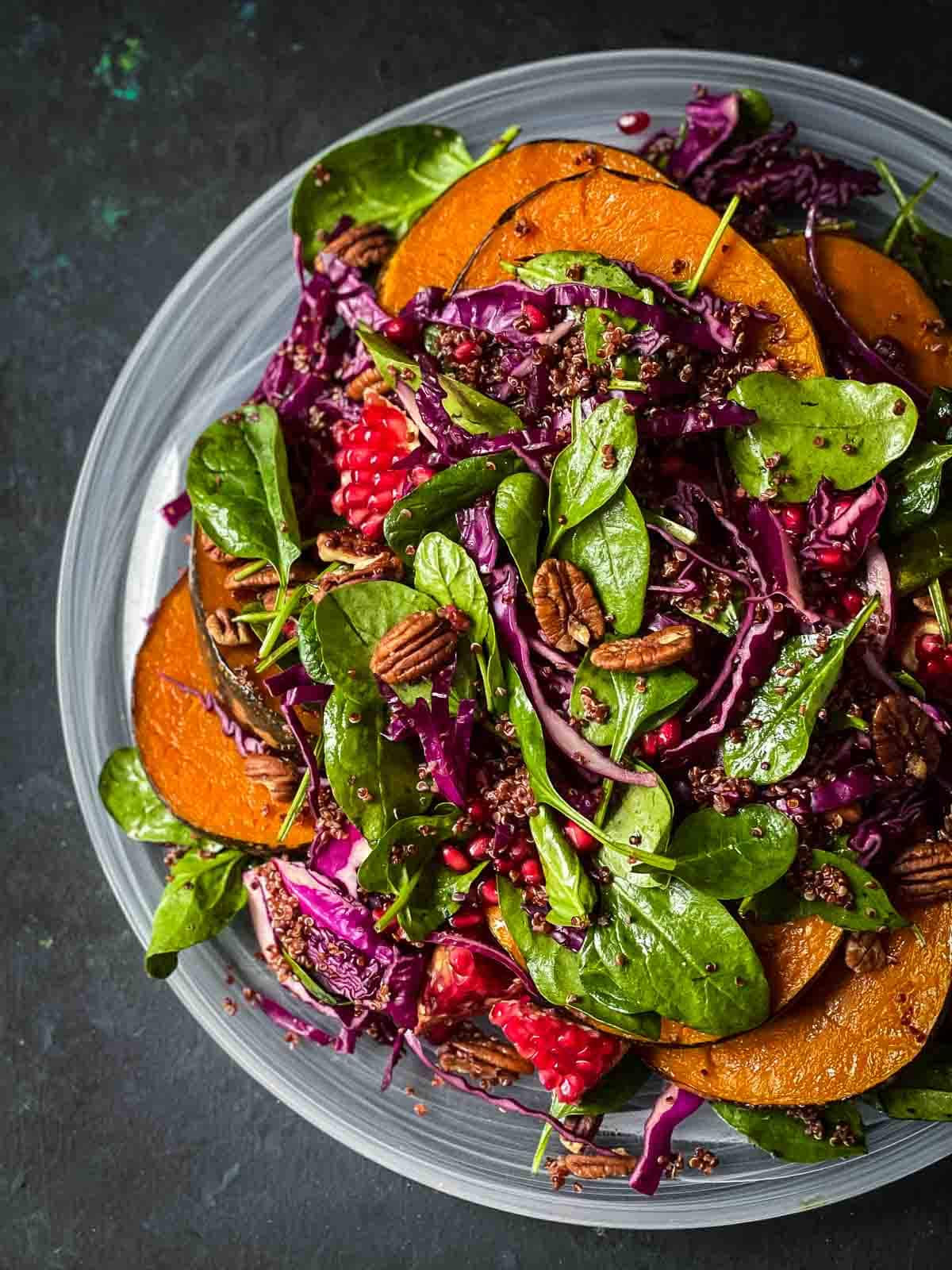 Quinoa Pumpkin Salad served on a white platter against a dark background