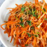 Carrot and Daikon Salad with Gochujang Dressing in a white bowl