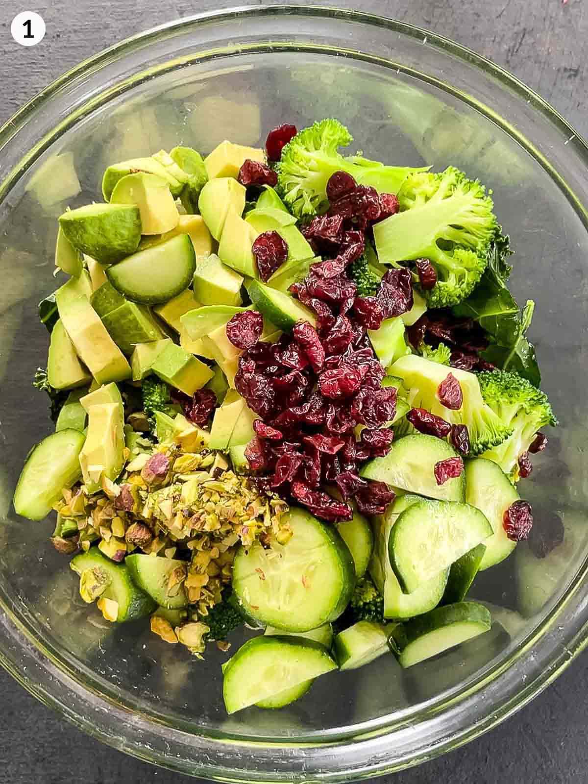 A mixing bowl of ingredients to make Cranberry and Kale Salad