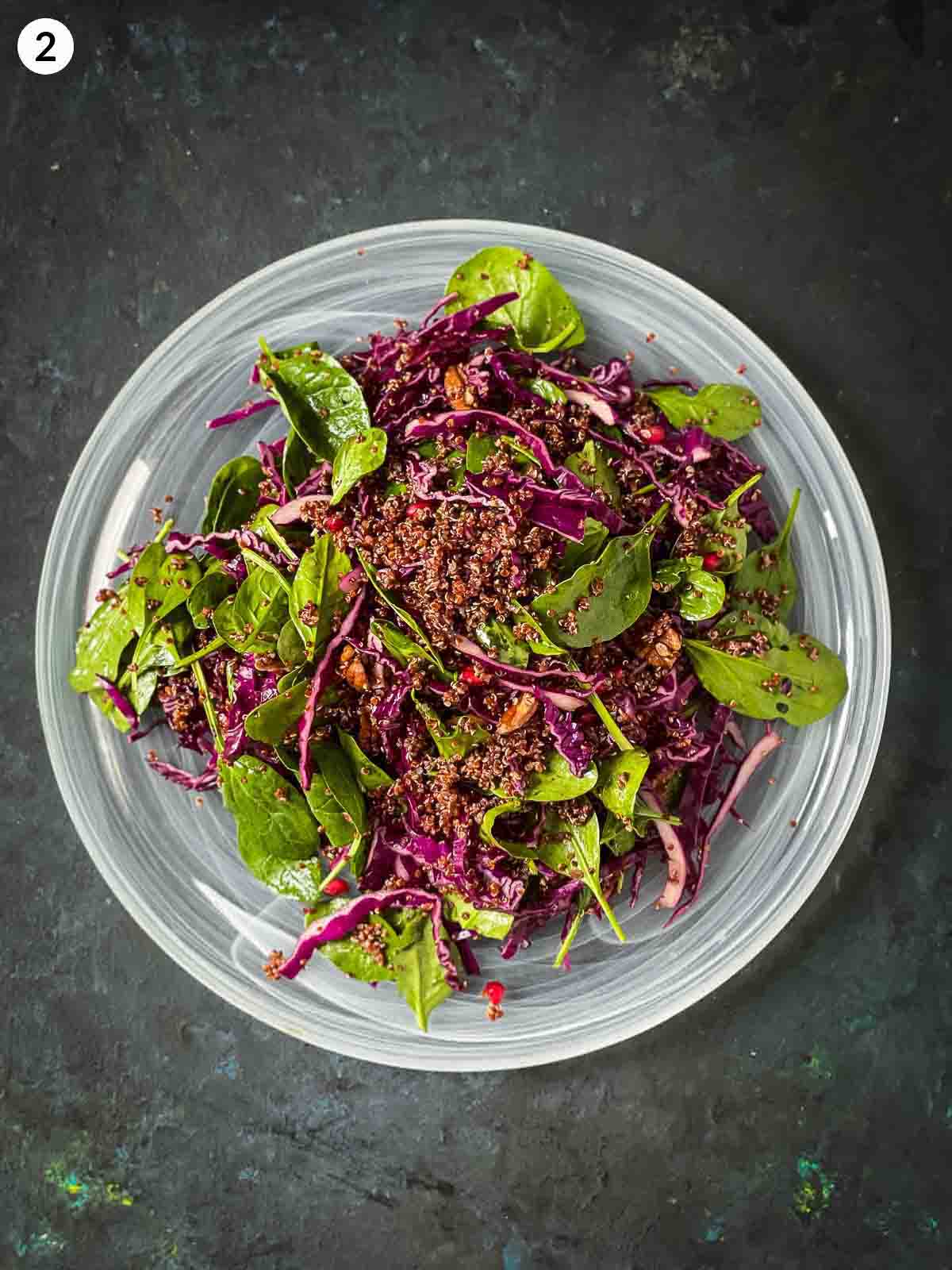 Assembling Quinoa Pumpkin Salad on a round white platter