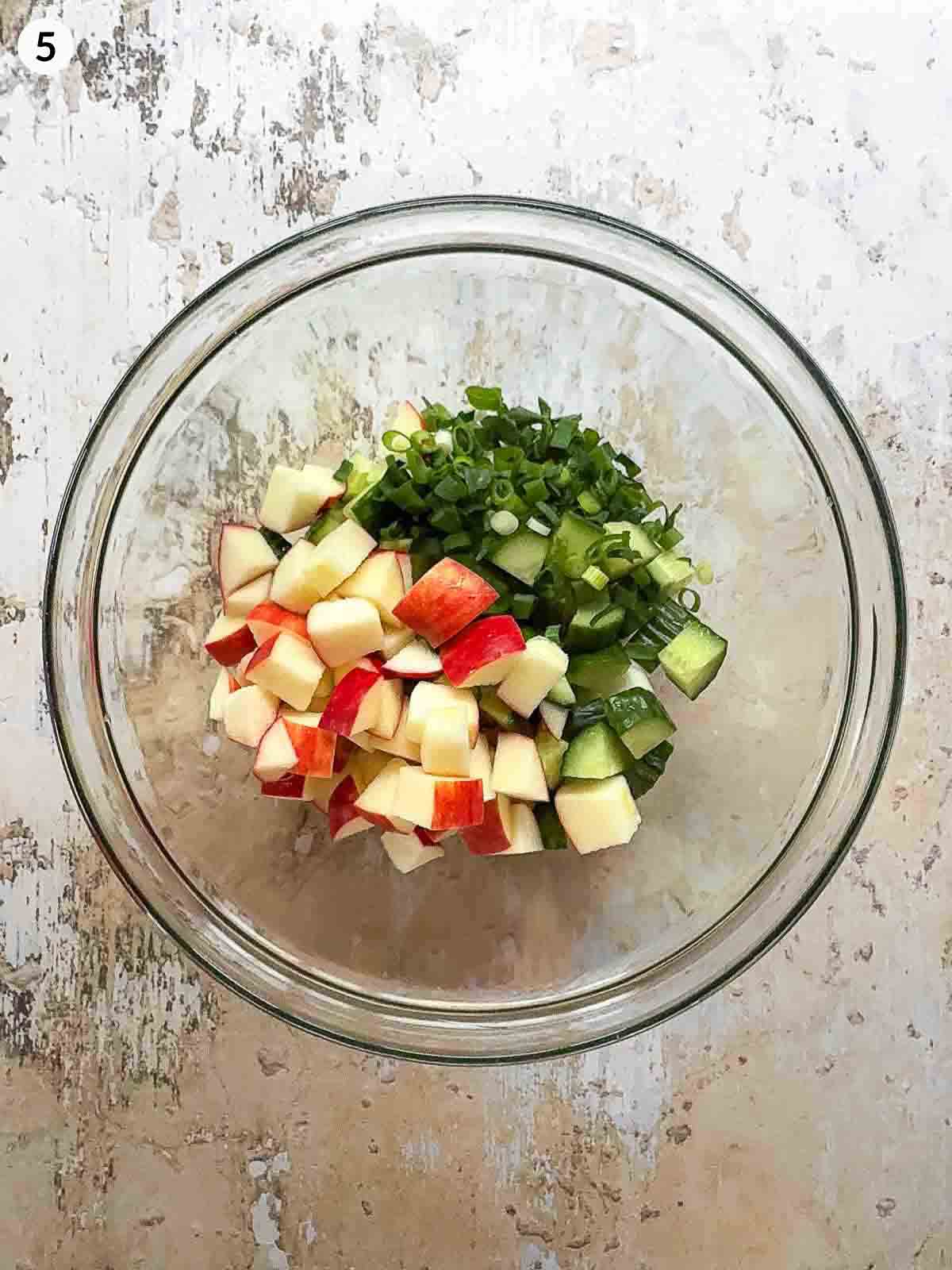 Daikon Cucumber Apple Salad ingredients in a clear bowl