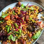 Roasted Chickpea and Carrot Baharat Salad on a grey platter against a dark background
