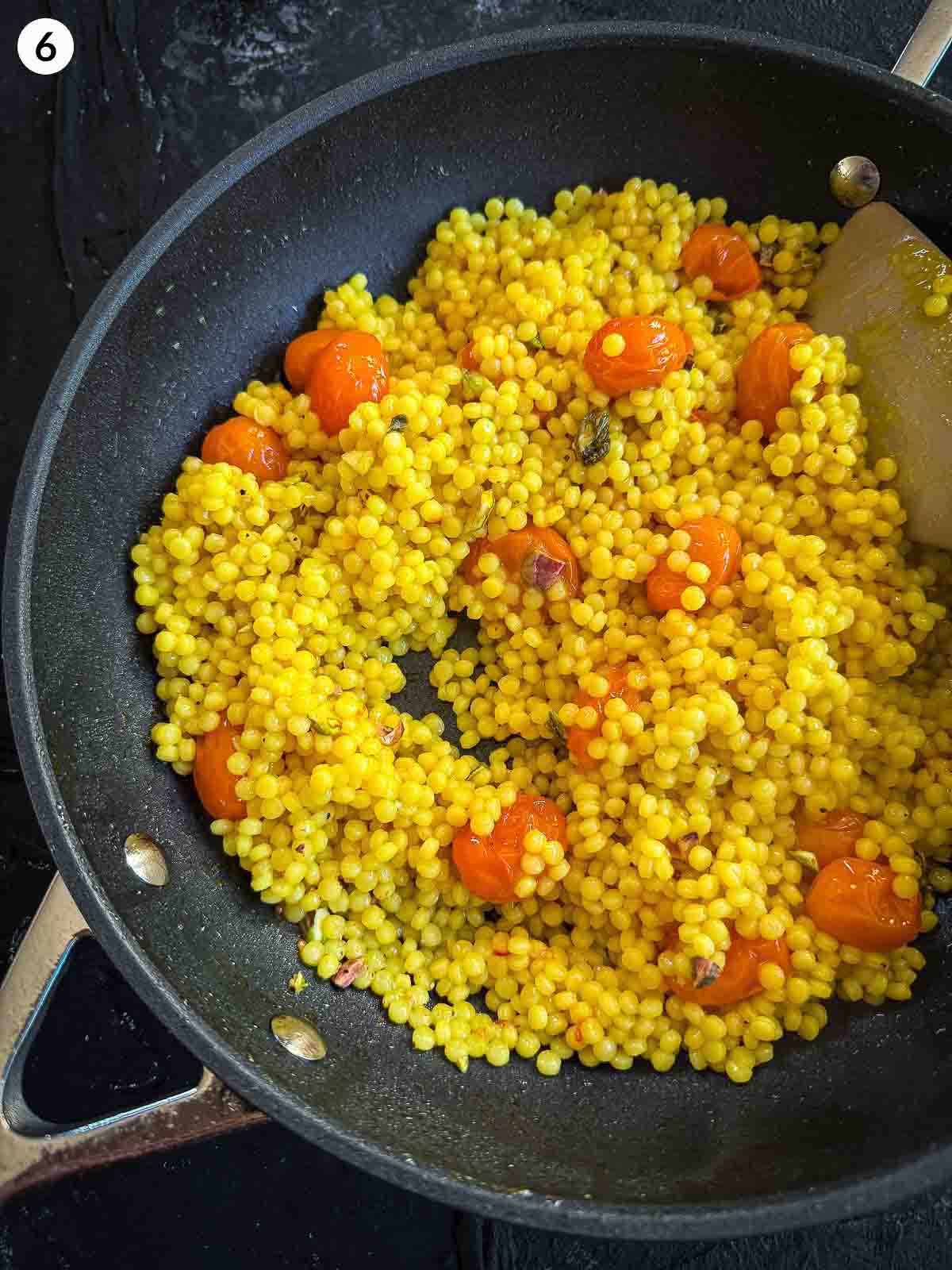 israeli couscous and tomatoes in a pan