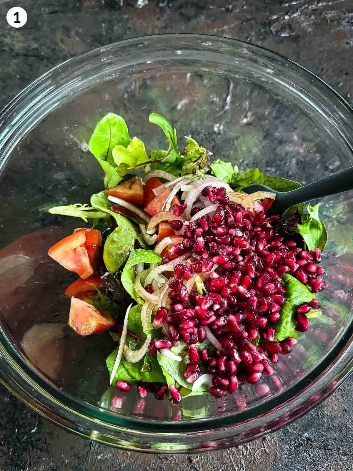 Mixing ingredients in a clear bowl for Roasted Chickpea and Carrot Baharat Salad