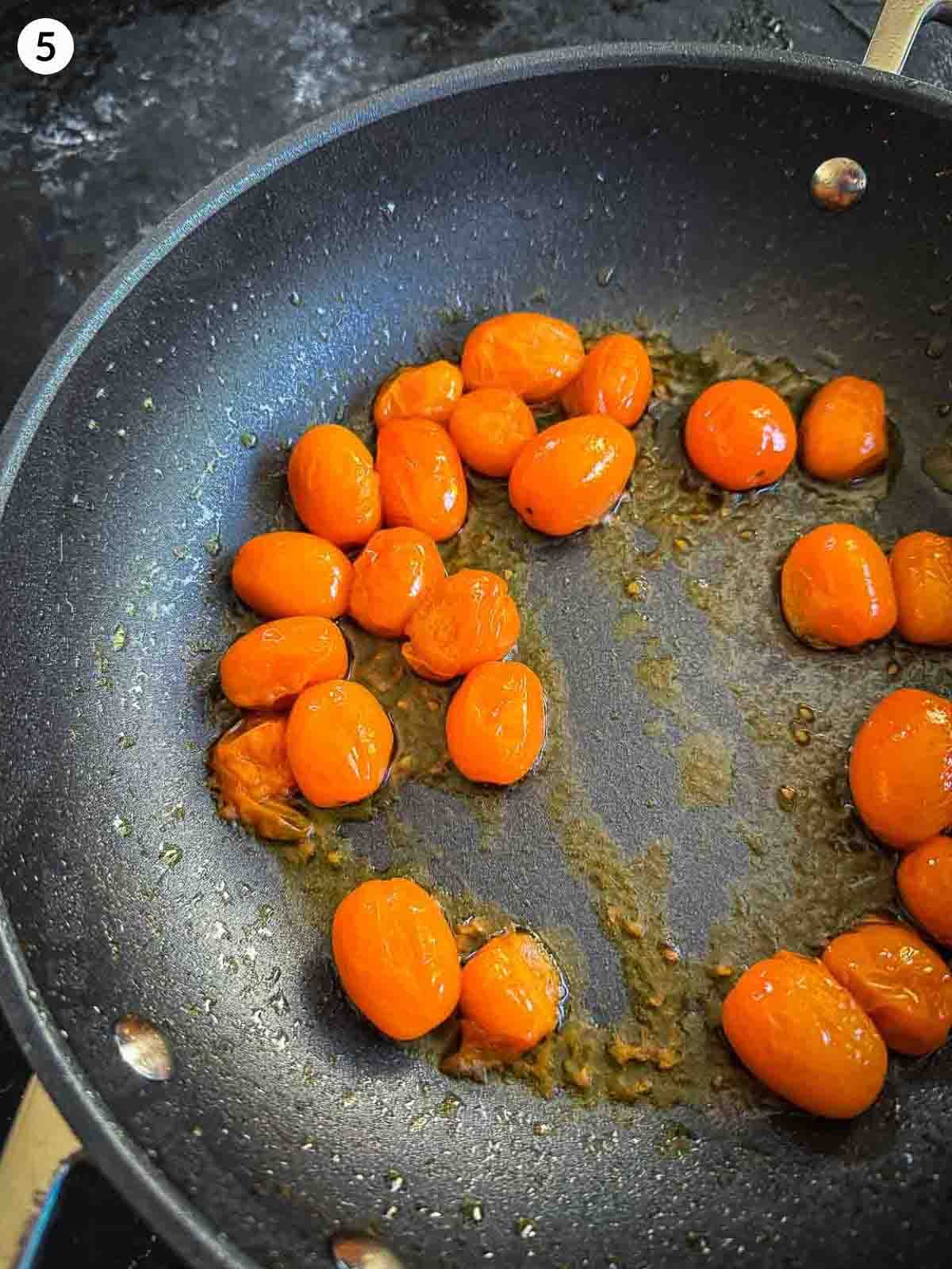 blistering tomatoes in a pan