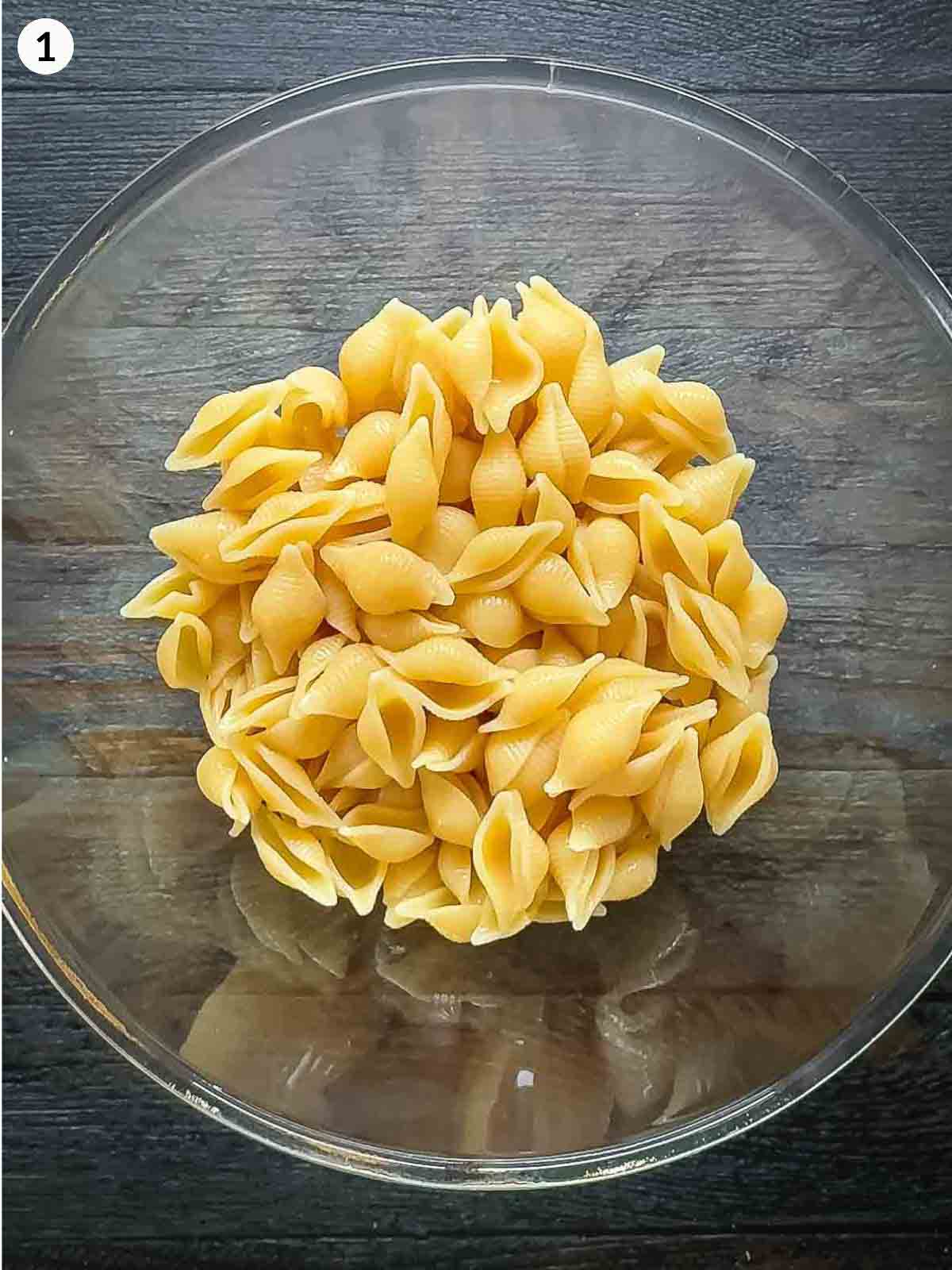 bowl of cooked pasta against a dark background