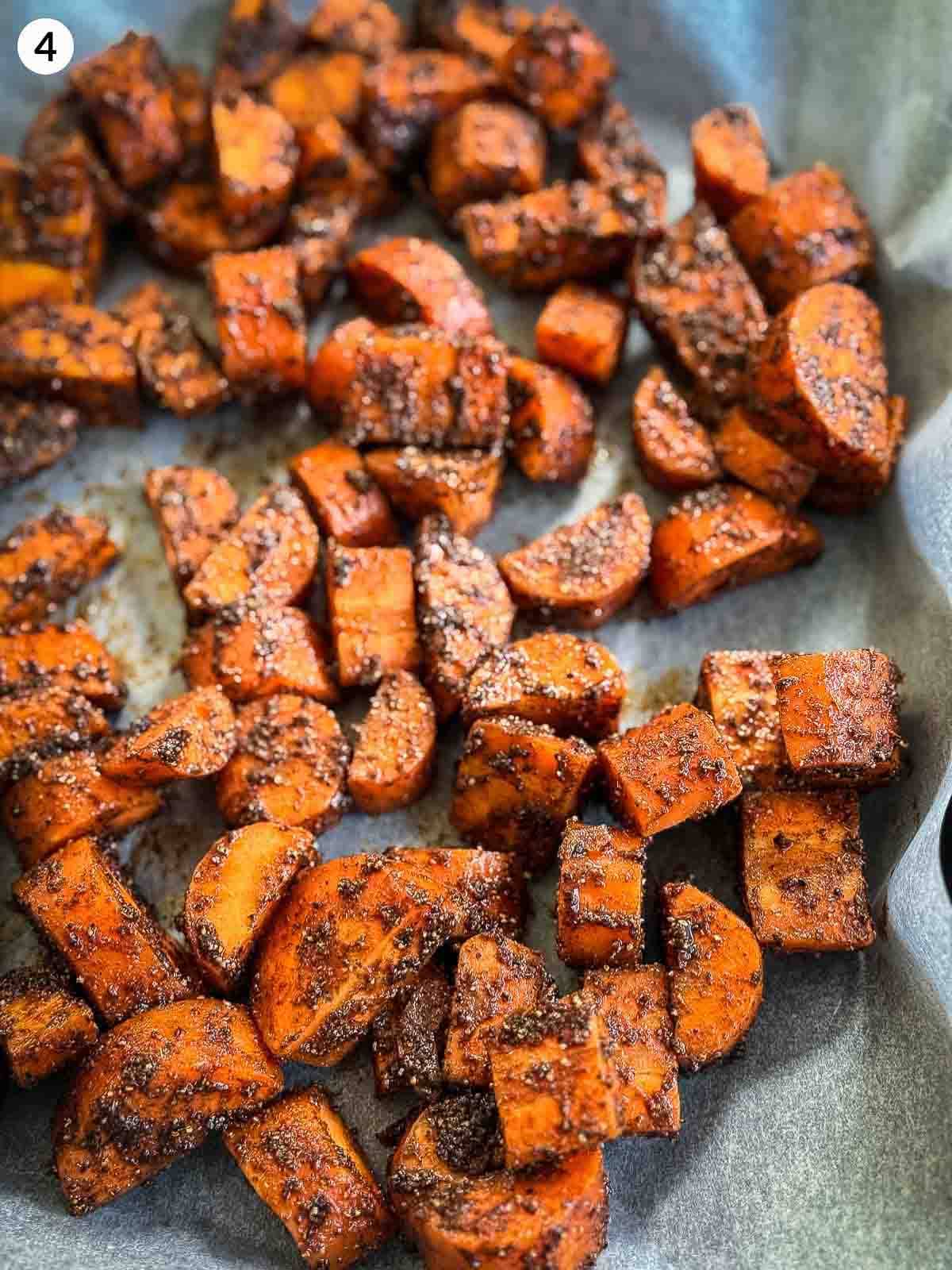 baharat spiced carrots on a parchment lined sheet pan