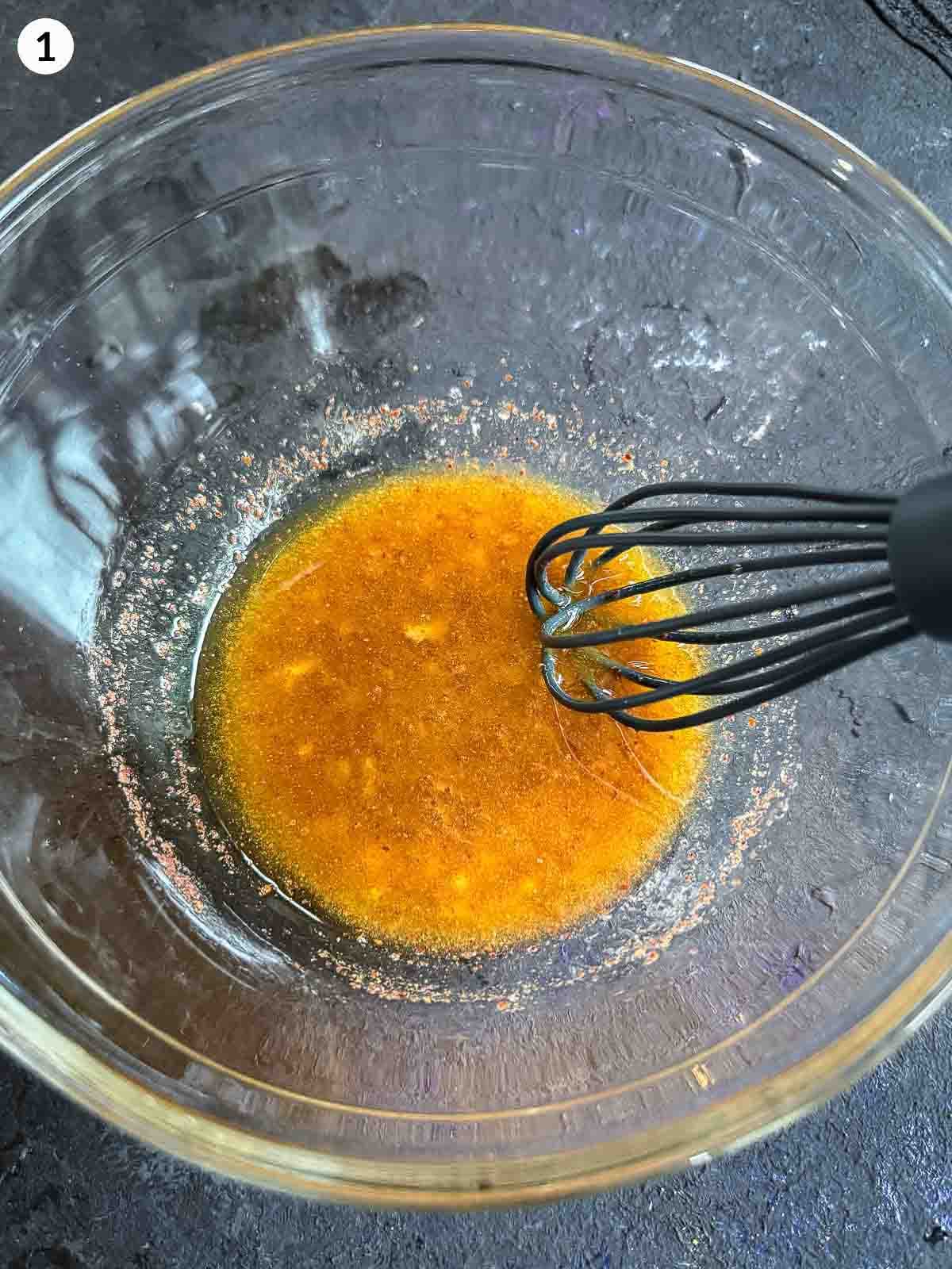 Whisking balela salad dressing in a creal bowl