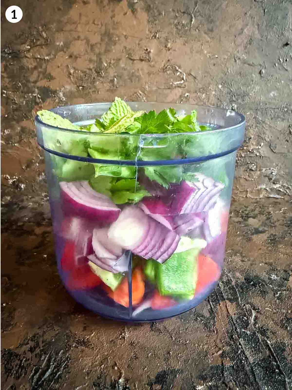 Ingredients for ezme salad sitting in a food processor