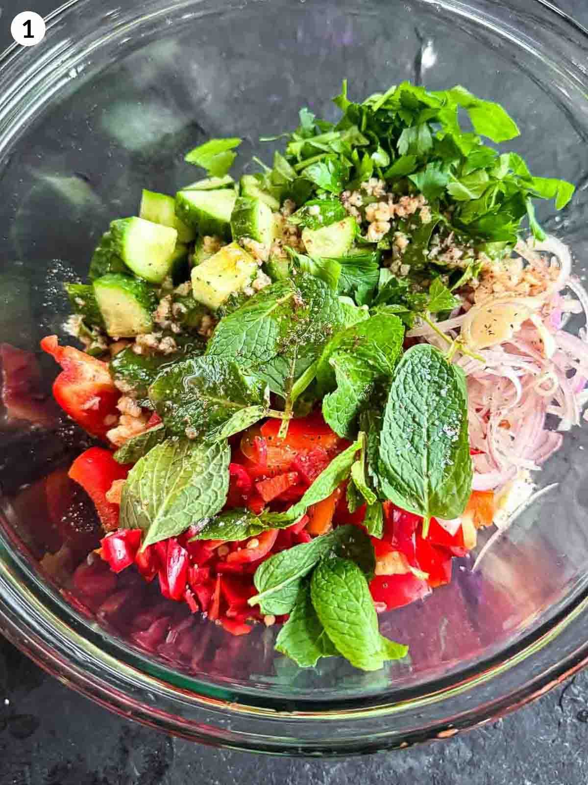 Balela Salad ingredients in a clear bowl