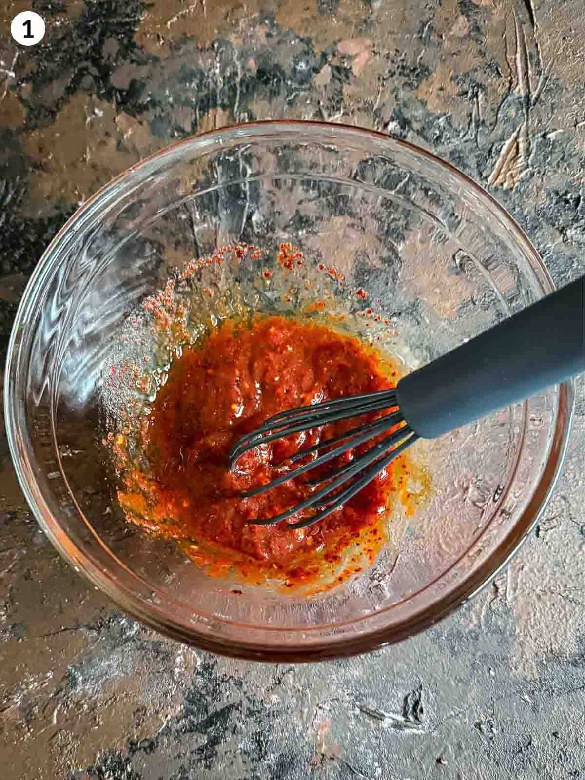 stirring ingredients for ezme salad sauce with a silicon whisk